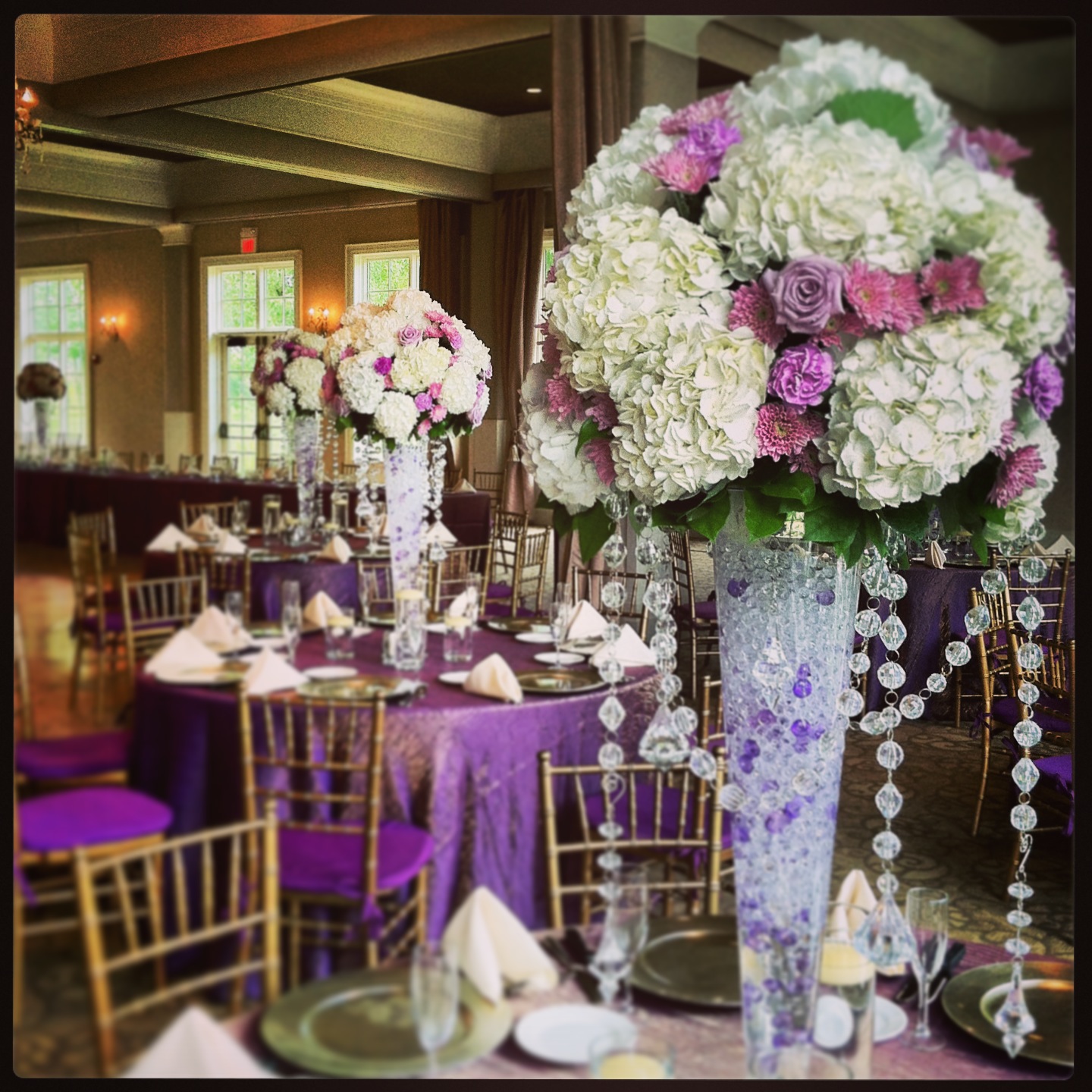 This Wedding Centerpiece was completed at the Pinnacle Golf Club and include crystals, Ocean Song Lavender Roses, Lavender Cushion Mums, White Hydrangea, Florigene carnations and accents of water gels