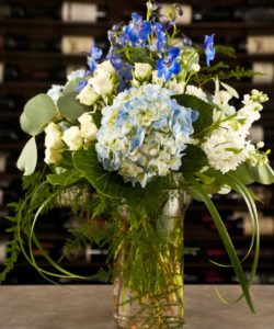 Blue hydrangea in tall glass vase
