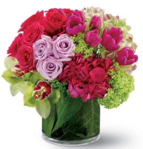 ping roses and tulips in glass vase