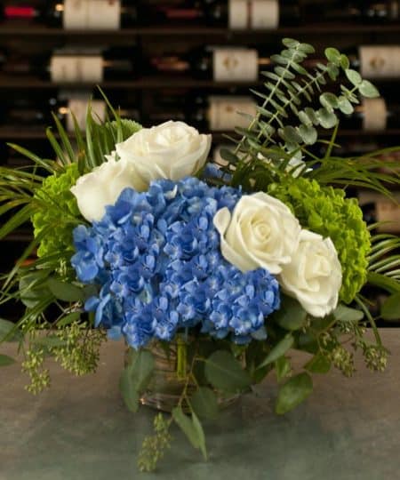 Blue hydrangea with white roses in vase