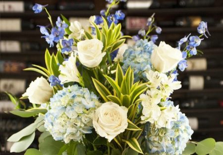 A full clean design packed with fresh flowers sure to be appreciated. Blue hydrangea, song of india focal greenery, white alstromeria, white Ecuadorian roses, blue candle delphiniu, and silver dollar eucalyptus.